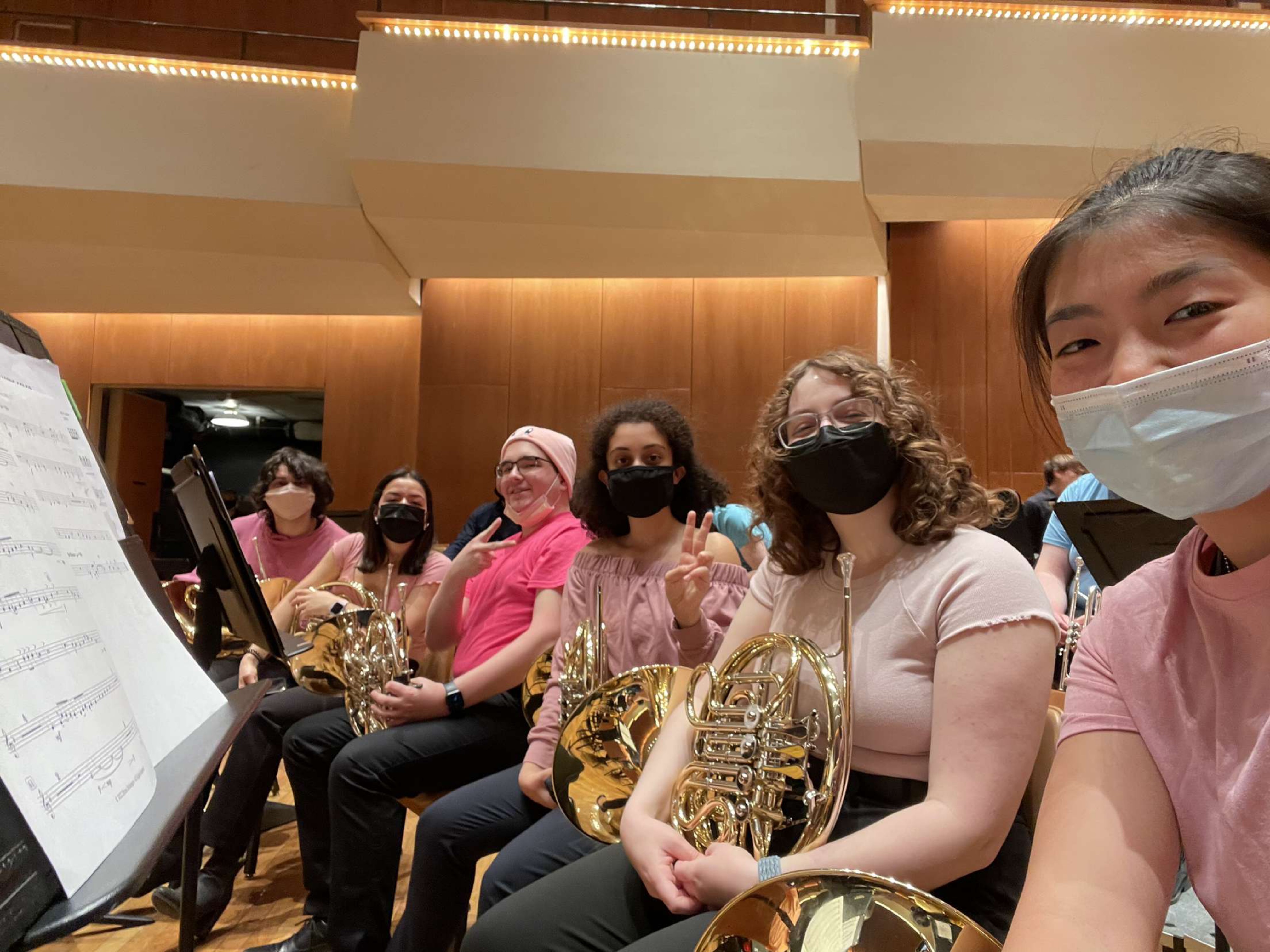 Eric Monson, fourth from right, with the French Horn section on the stage in the Great Hall at Krannert Center for the Performing Arts.