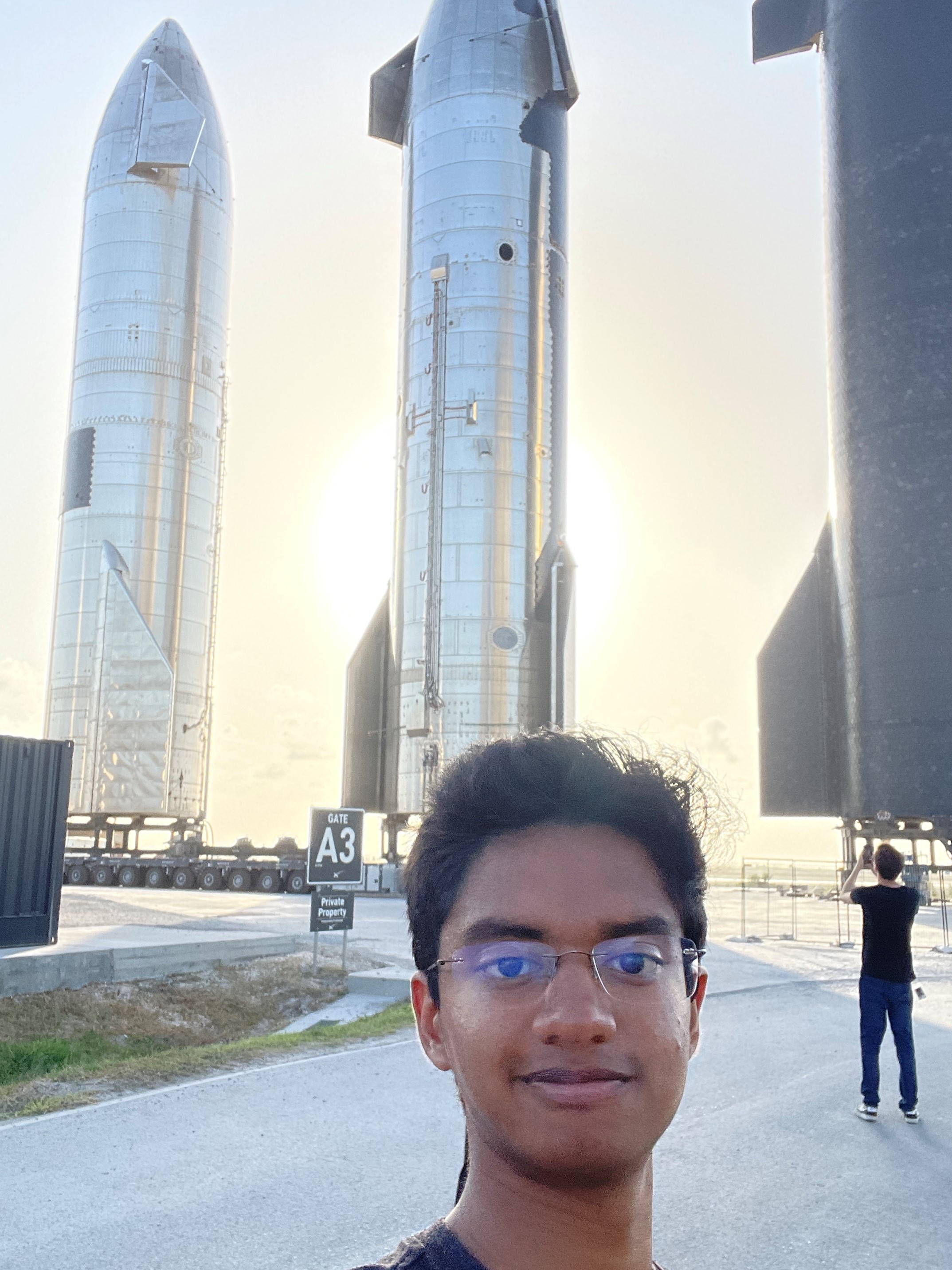 Anshuk Chigullapalli with Starship rocket at Starbase, Texas where he'll be working this summer.