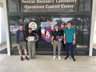 On their first day at the Neutral Buoyancy Lab for testing were, left to right: manufacturing lead Jeremy Zang, testing lead Aliah Rubio, lead Alex Brouillette, and team member Evan Jurcenko.