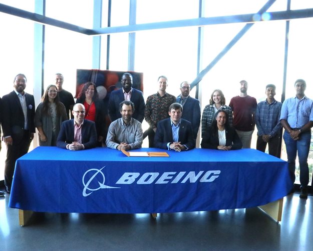 AE faculty and graduate students witnessed the signing ofa pledge from Boeing in support of sustainable aviation at Illinois. Seated left to right: AE Associate Professor Phillip Ansell, Professor and Dept. Head Jonathan Freund, Boeing Vice President of Sustainability and Future Mobility James Hileman, and Boeing Director of Sustainability Performance and Integration Elia Morales. Standing behind Hileman and Morales are representatives from Boeing Colin Tully, Dominic Barone, and Kristin Holland.