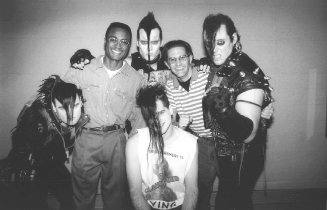 : From the early 90s: Derek Smith, left, with his coworker Bob Davis in the striped shirt, and members of the band The Misfits, who had just signed with Geffen Records.