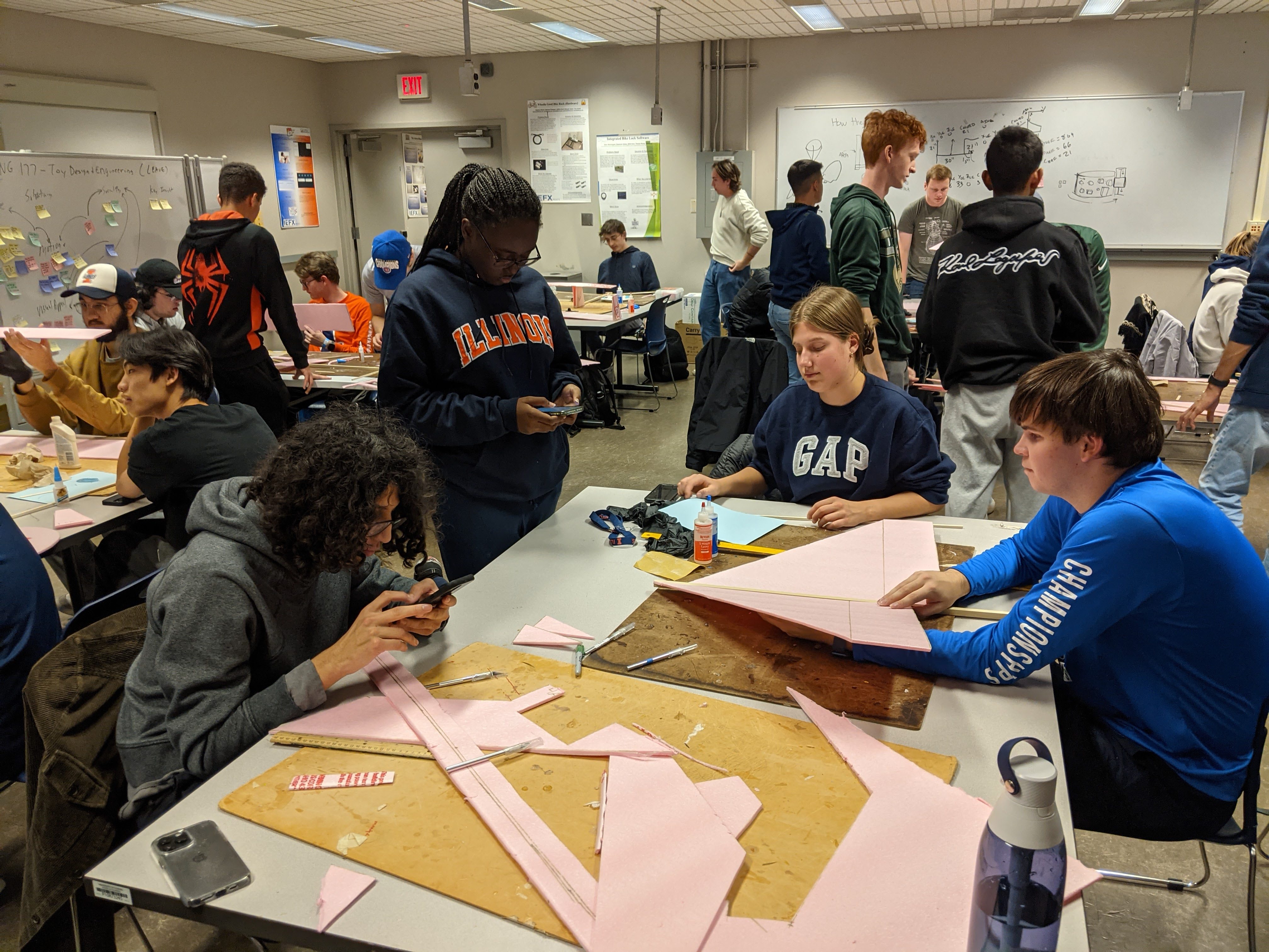 A glider build session with Team 4 in the foreground clockwise from lower left: Matthew Giraldo, Tiana Foreman, Emily Douglas, and Riley Walters. Their glider had good overall test flights.