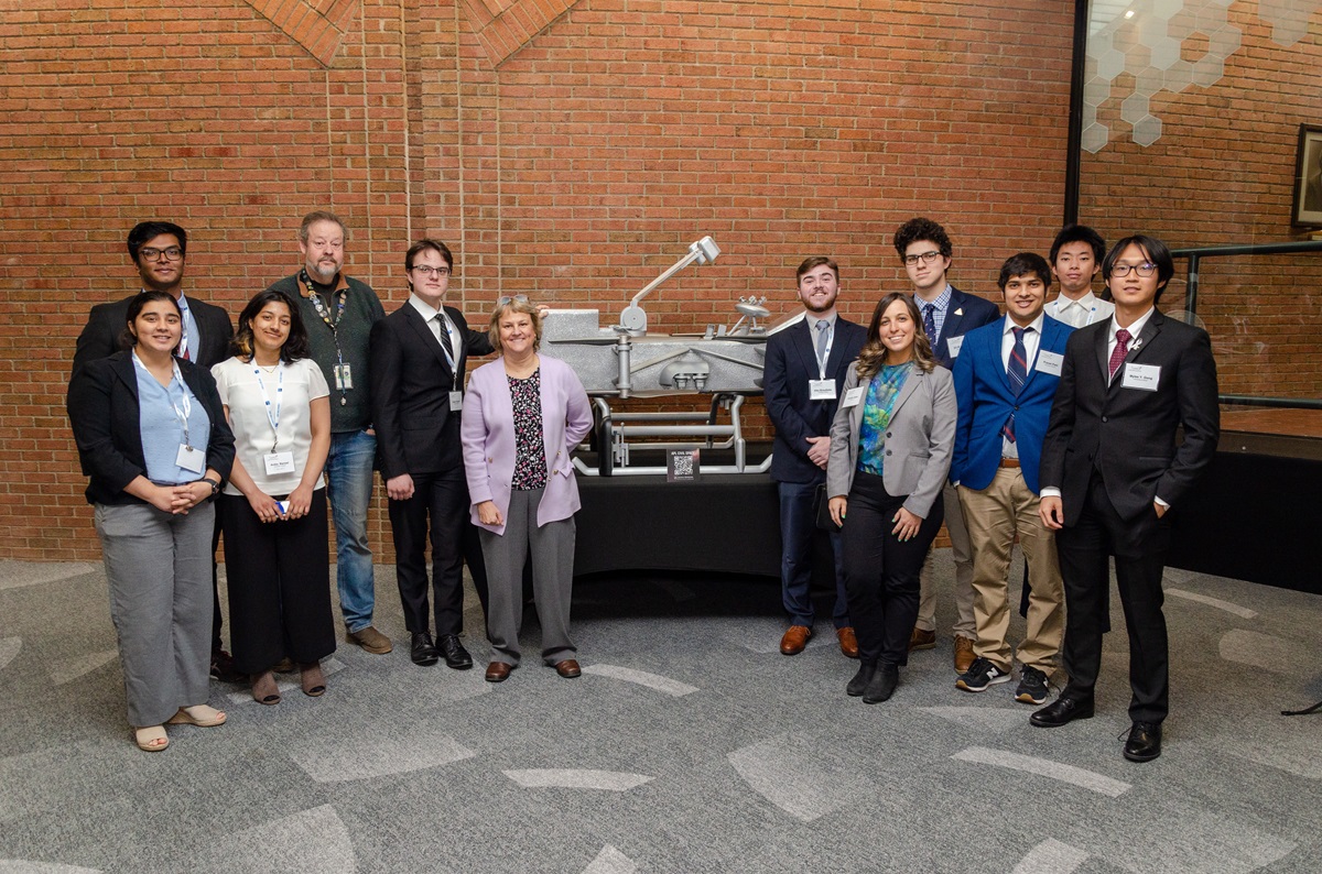 Coralie Adam front right with Illinois Space Society students and other UIUC alumni at the 2023 American Astronautical Society Goddard Space Science Symposium