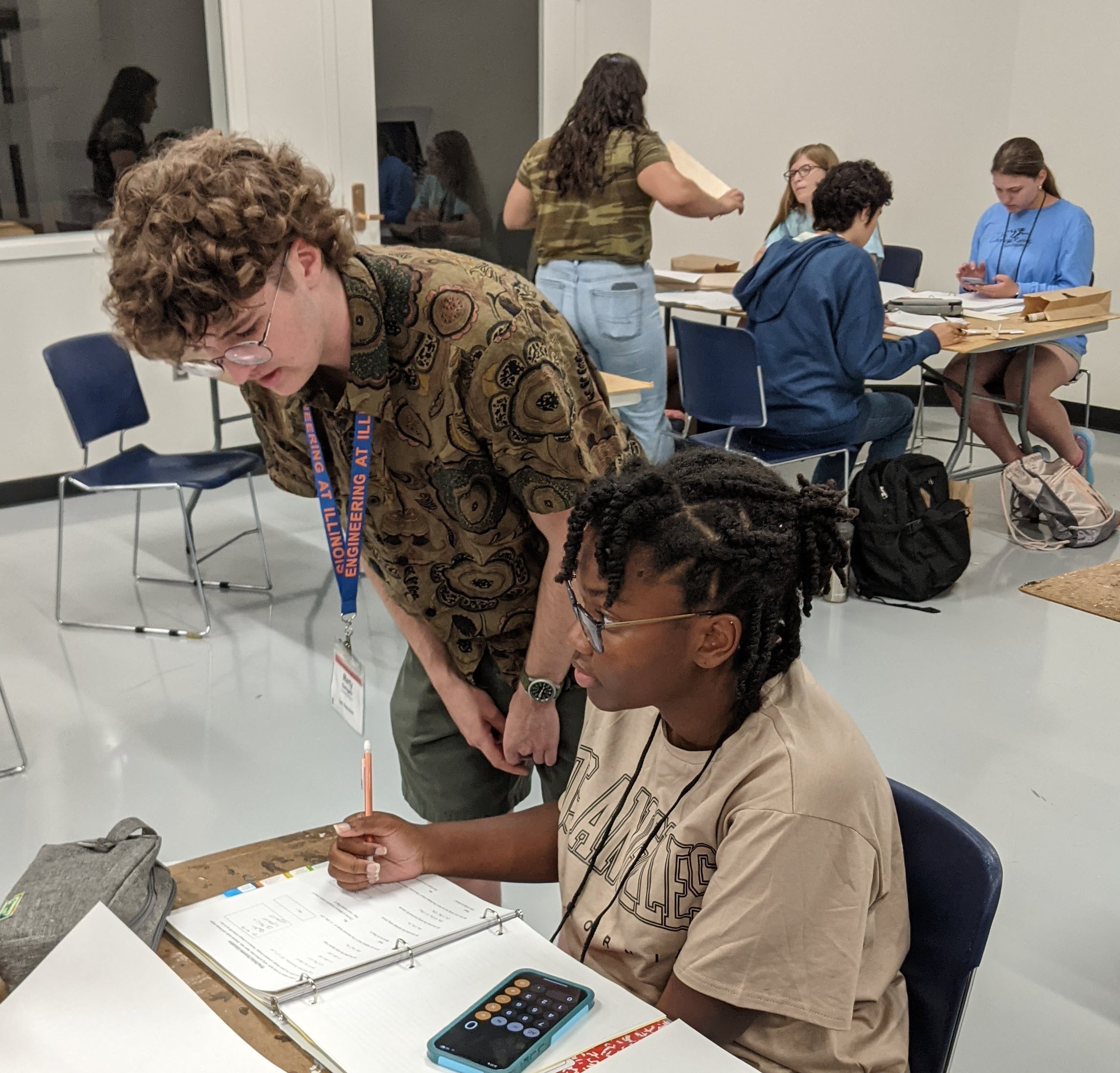 Bathgate assisting a student at a summer camp build session