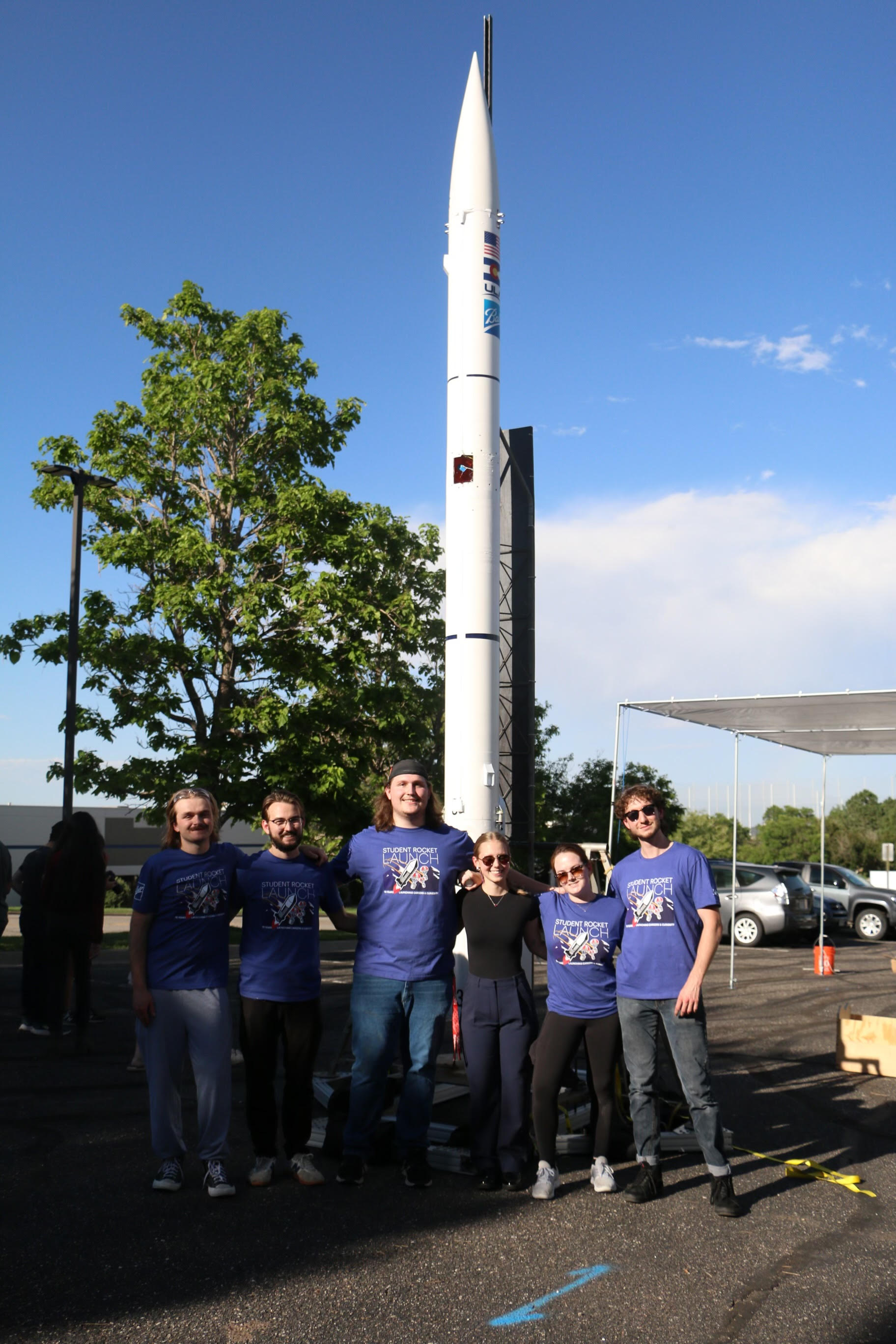 O'Donnell far left with with other United Launch Alliance interns posing with the intern rocketry program rocket.