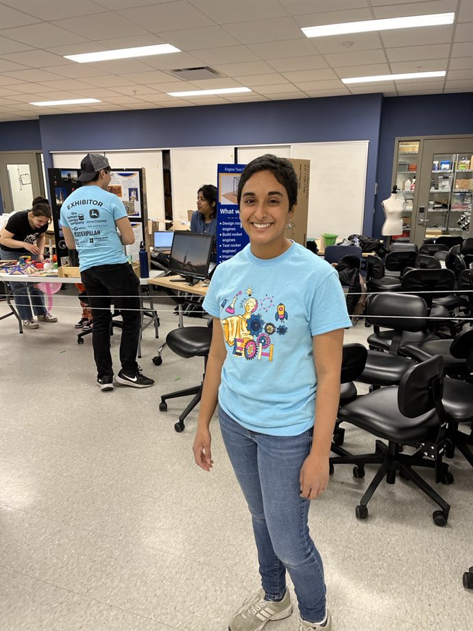Patel helping at one of six Illinois Space Society exhibits at the 2024 Engineering Open House.  Visitors could make their own balloon rocket and &amp;quot;launch&amp;quot; them on the string, seen behind her.
