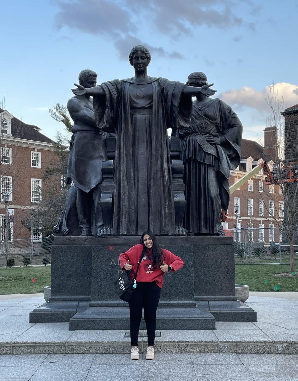 Angel Agrawal posing with the Alma Mater