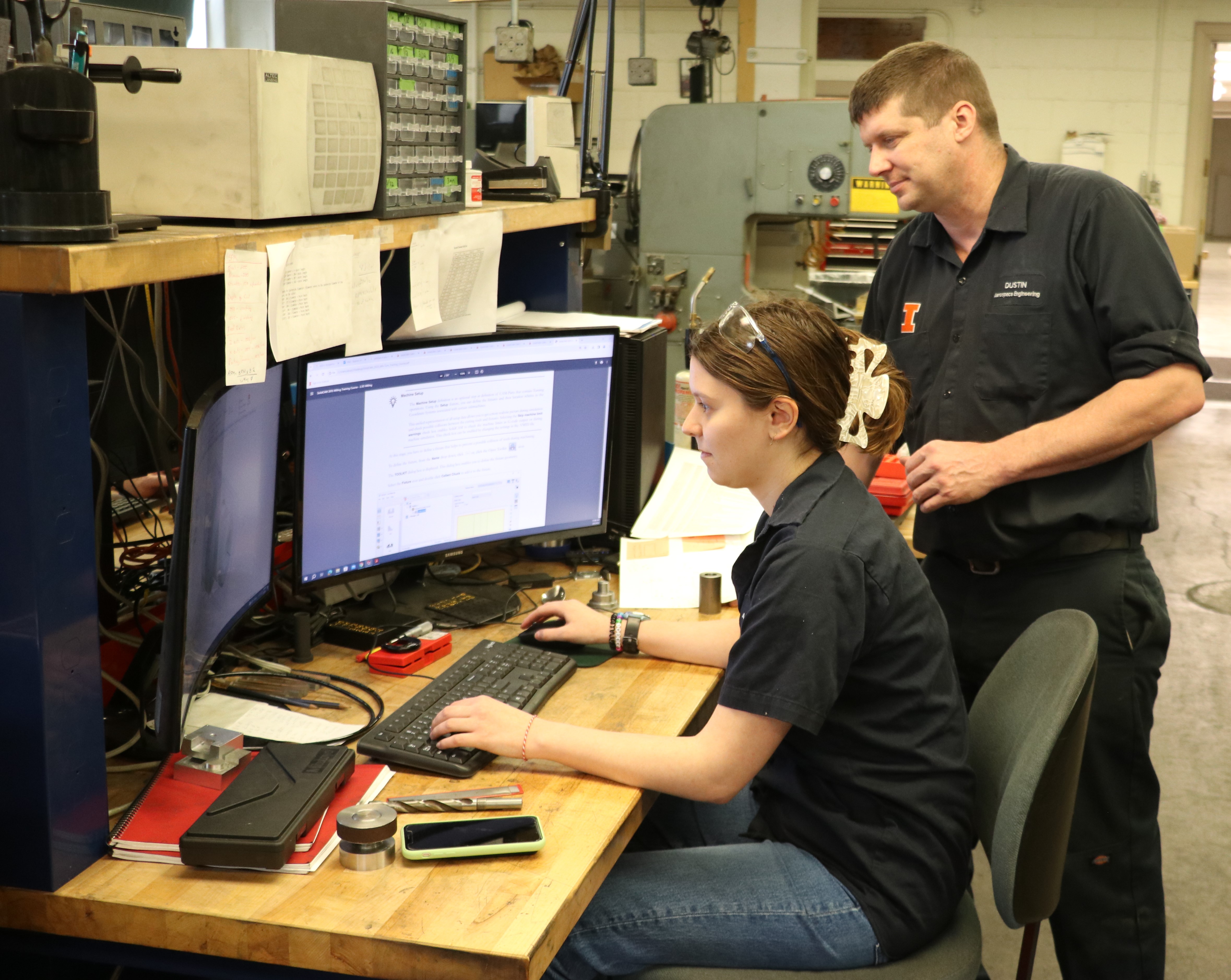 Ana Bojinov working in the Talbot Machine Shop with her superviser Dustin Burns.