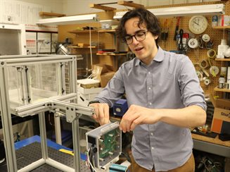 Ph.D. student Nicolas Rasmont assembling his radar inferometry instrument in the lab.